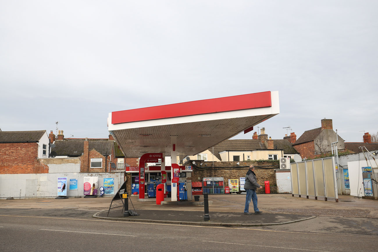 A solitary man at a petrol station in the middle of Oakham, Rutland