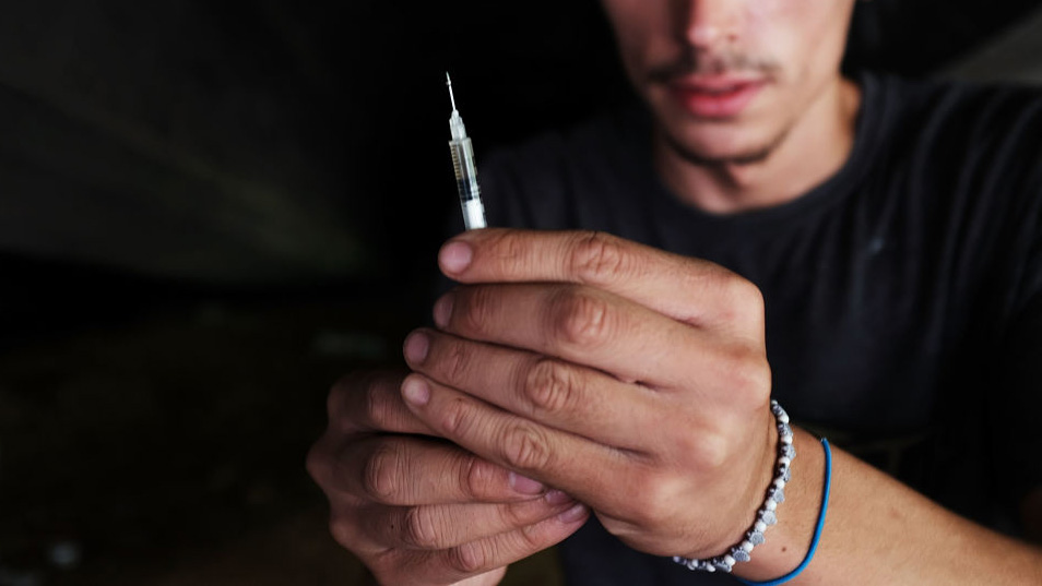 man holding syringe