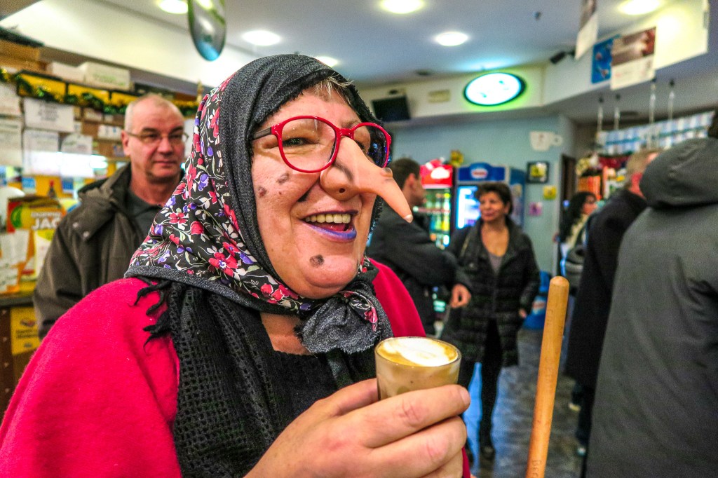 A woman dressed up as Befana at an Italian grotto