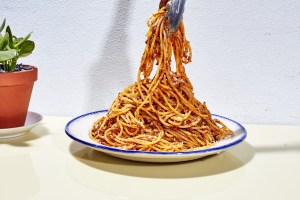 a plate topped with spaghetti in an easy beef bolognese sauce