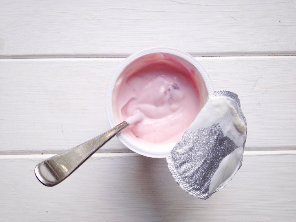 cup of flavored yogurt with a spoon