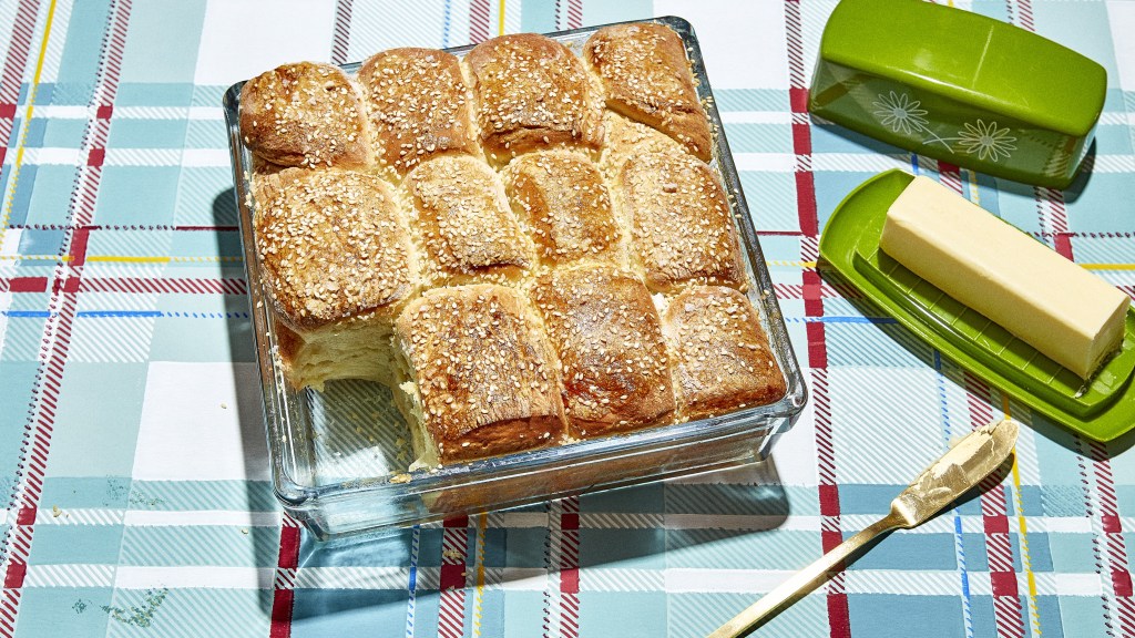 a glass baking dish full of homemade parker house rolls