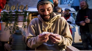 Man rolls a joint on the first day of weed legalization in Canada.