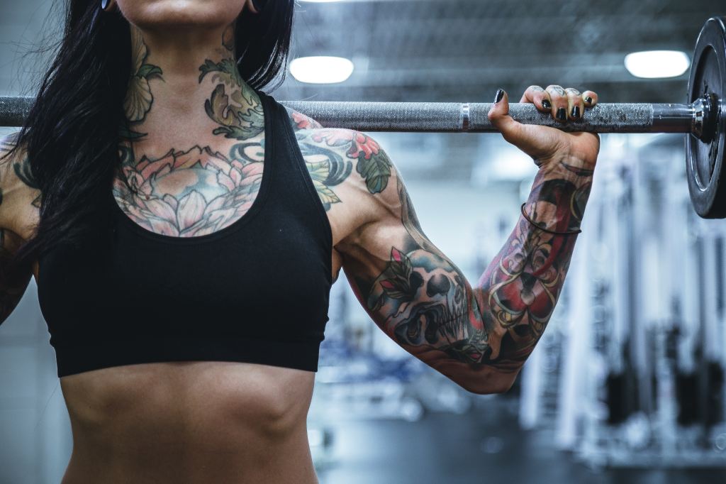 Tattooed woman working out in the gym