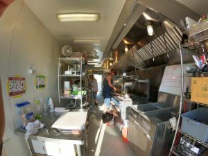 two men cooking in an auto camper