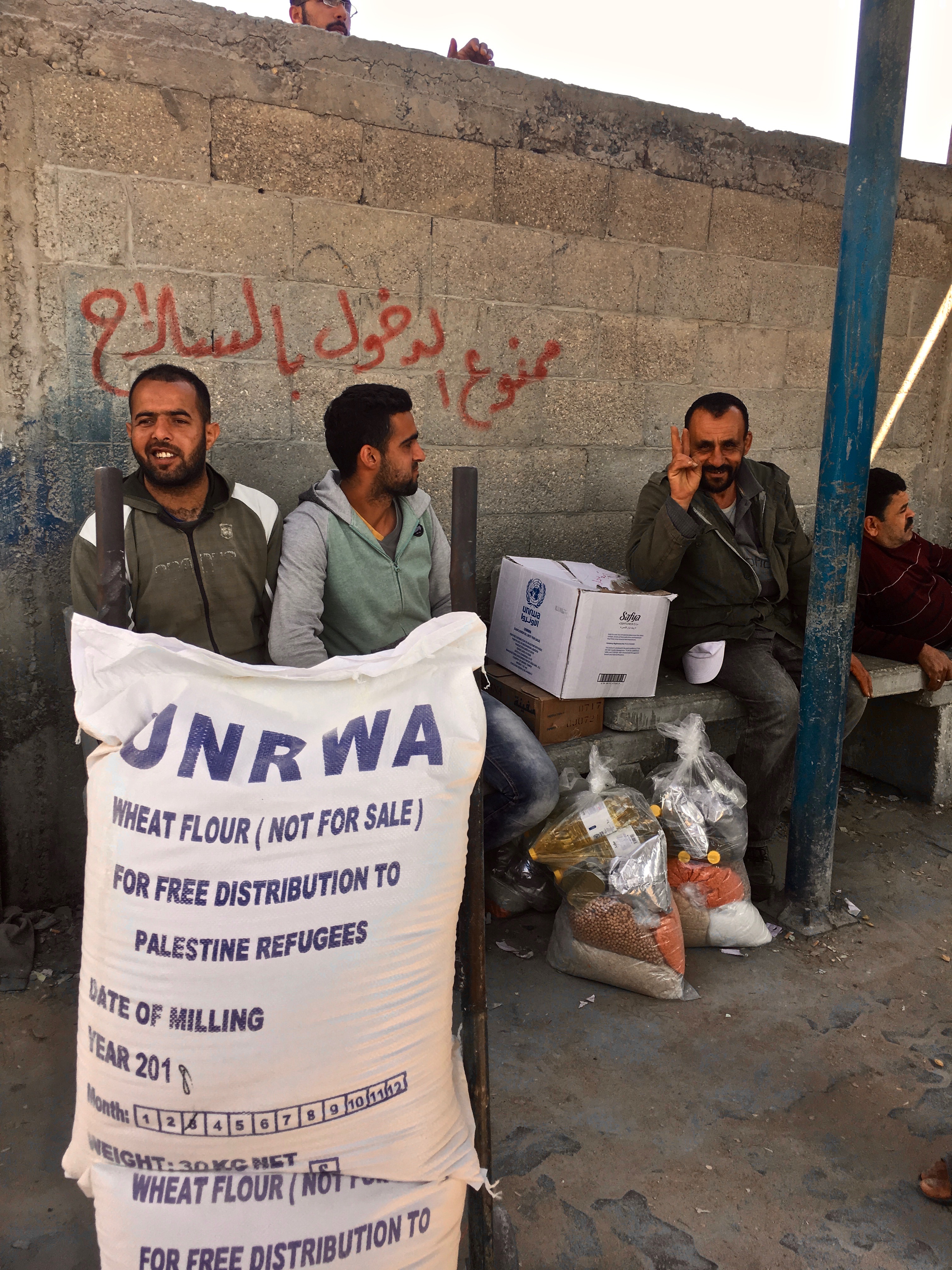 1540313338960-outside-an-UNRWA-dist-center-the-writing-on-the-wall-says-entrance-with-weapons-forbidden