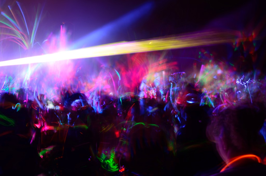 A rave party with lasers and glow sticks