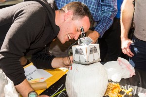 An engineer carving a pumpkin