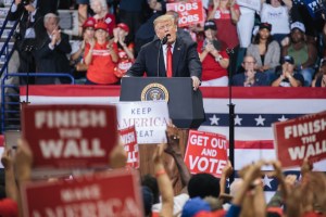 Donald Trump address the crowd at a rally.