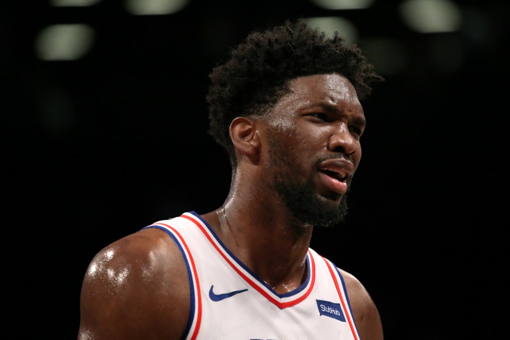 Joel Embiid reacts to a foul whistled against him in a game against the Brooklyn Nets