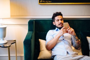 Man slouching on a hotel couch