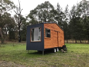 A tiny house in a field