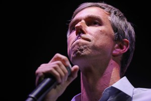 Beto O'Rourke holds a microphone.