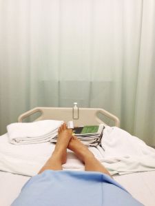 Patient in hospital bed with feet visible