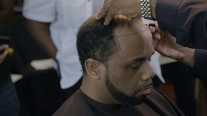 This barber’s “magic” man weaves are curing baldness for black men