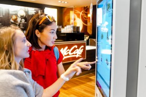 People using a McDonald's self-service touchscreen