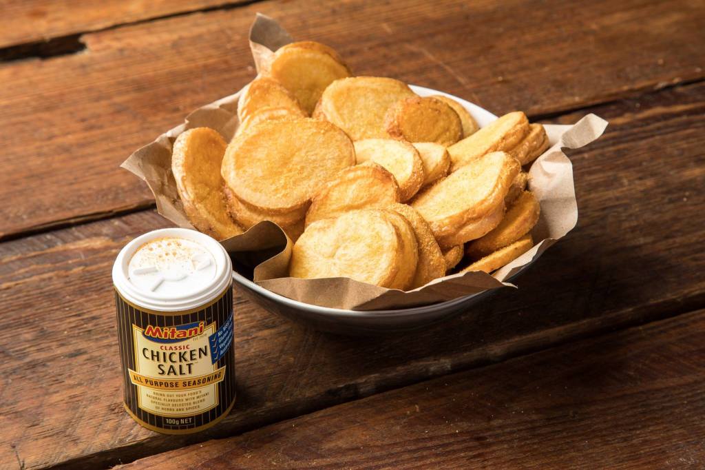 Mitani chicken salt next to a bowl of chips