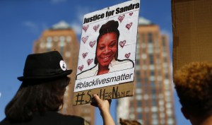 protestor holding Sandra Bland sign