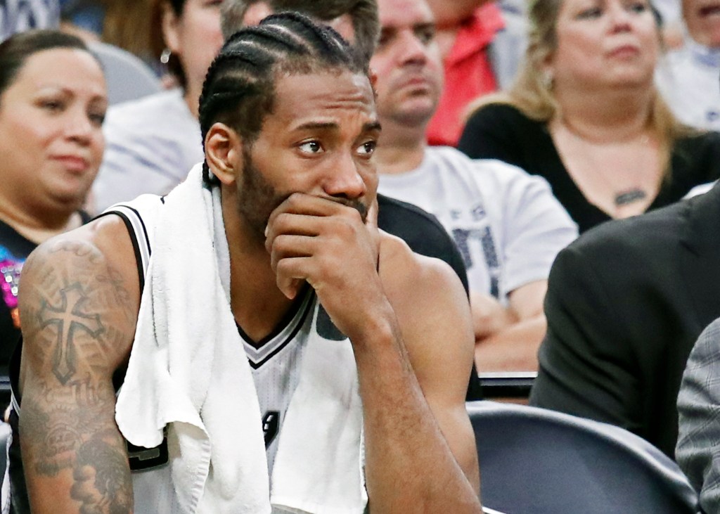 Kawhi Leonard sits on the bench during the San Antonio Spurs playoff run, contemplating Santa Claus.