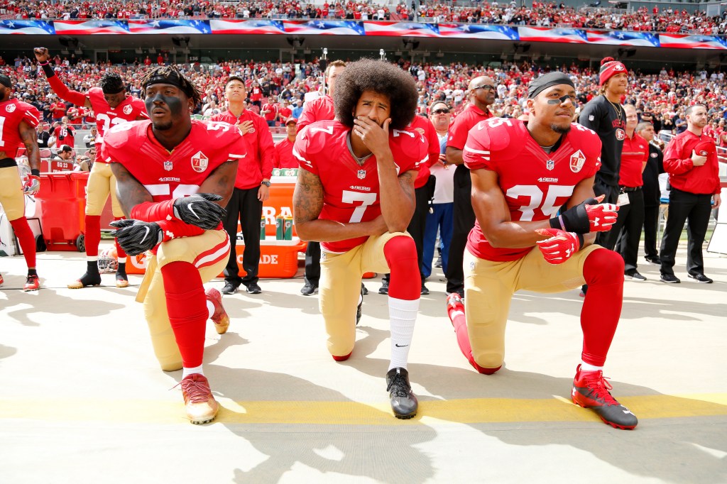 Eric Reid kneels alongside Colin Kaepernick during national anthem.