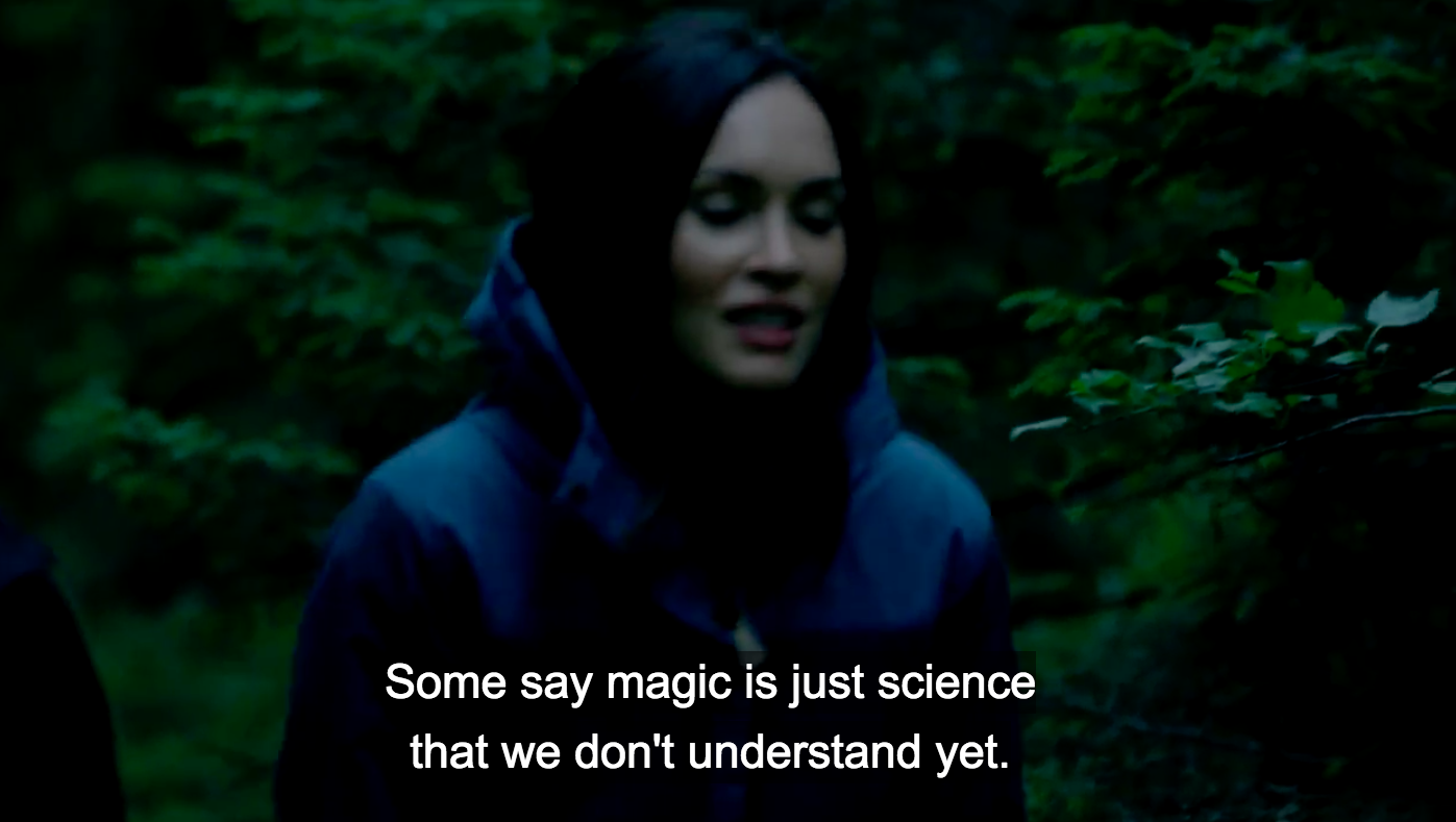 Megan Fox walking through a forest. A subtitle says