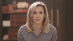 Image of Tamara Holder looking directly at the camera in front of a bookshelf.