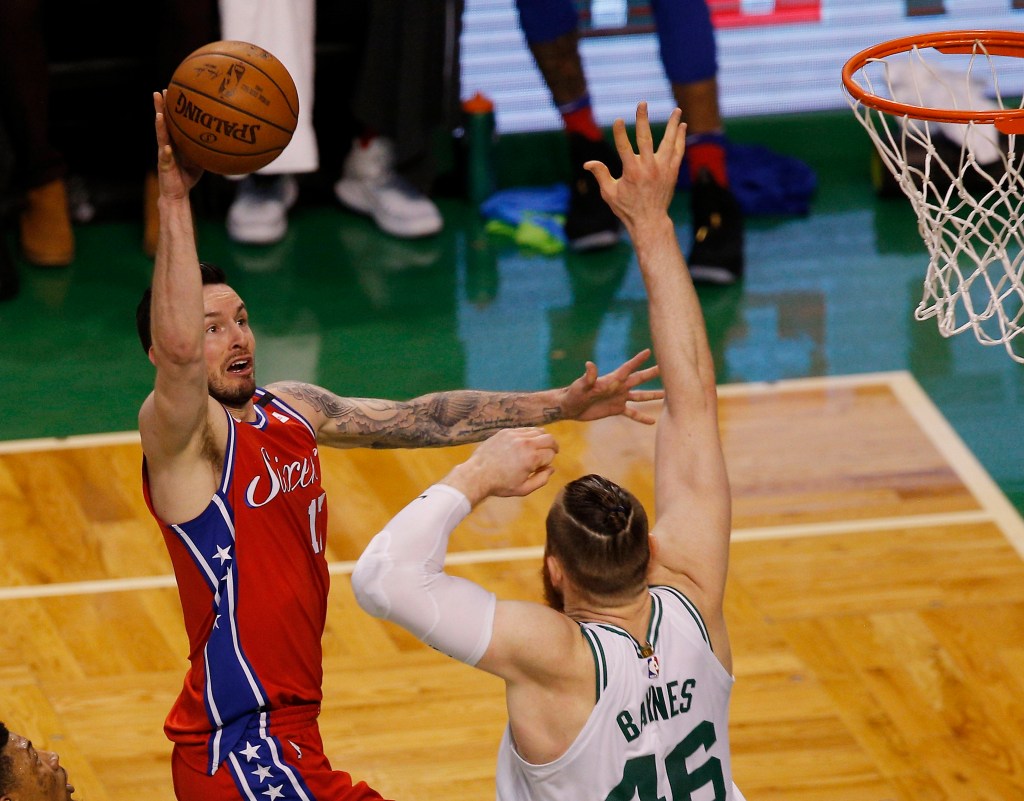 Philadelphia 76ers guard JJ Redick lofts a floater over Aron Baynes.