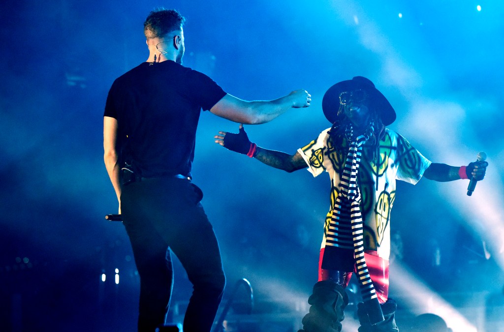 Dan Reynolds of Imagine Dragons (L) and Lil Wayne perform during the 2019 ESPN College Football Playoff halftime performance. (Photo by Tim Mosenfelder/Getty Images)