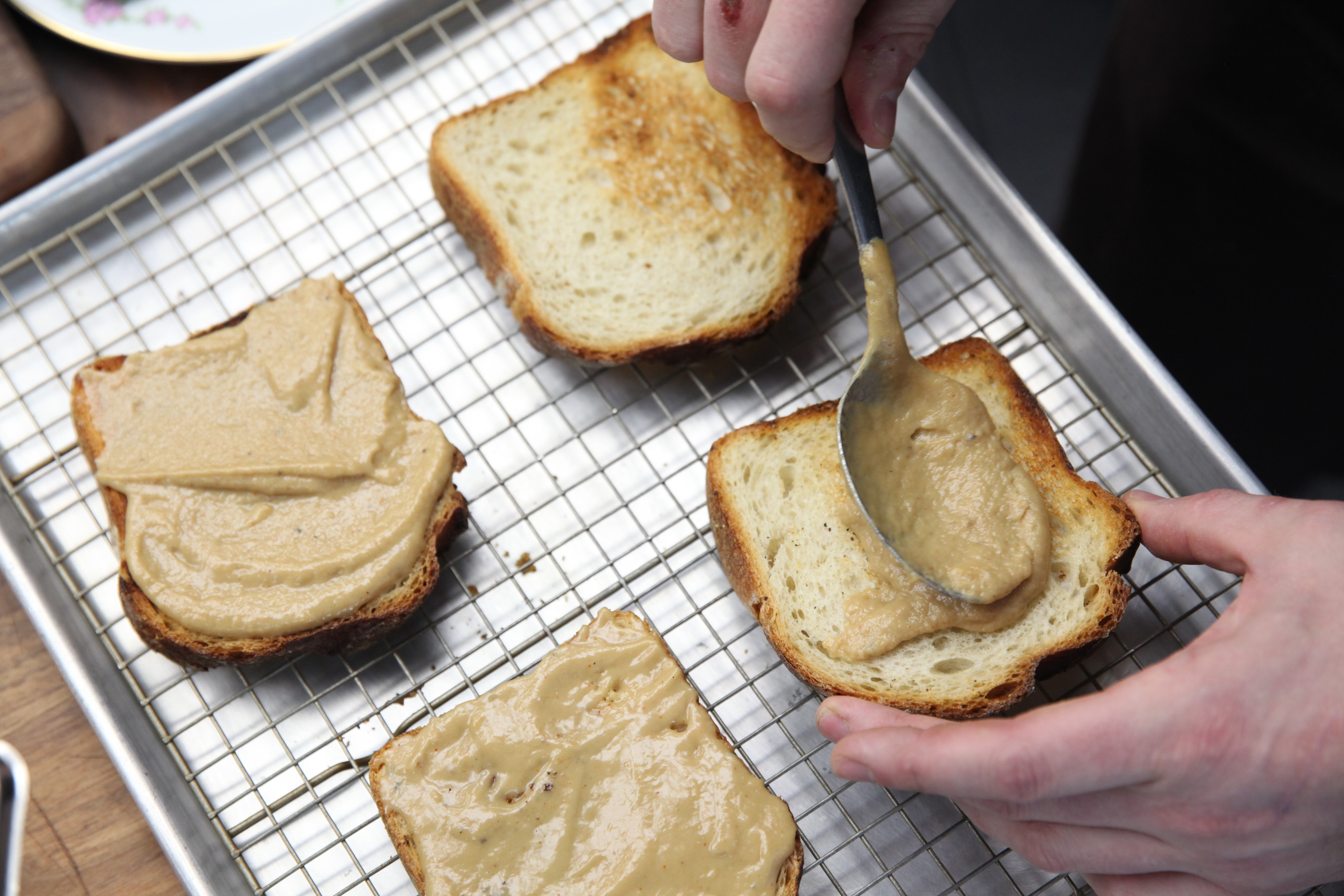 spreading welsh rarebit mixture onto bread