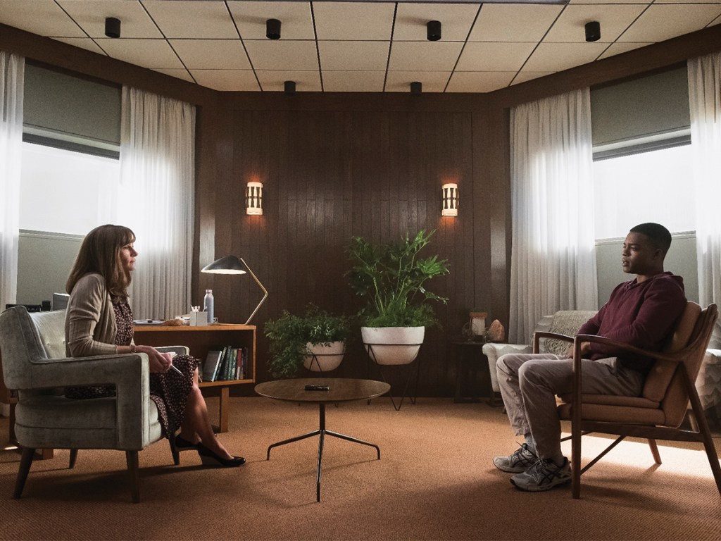 Julia Roberts and Stephan James sit across from one another in Homecoming.