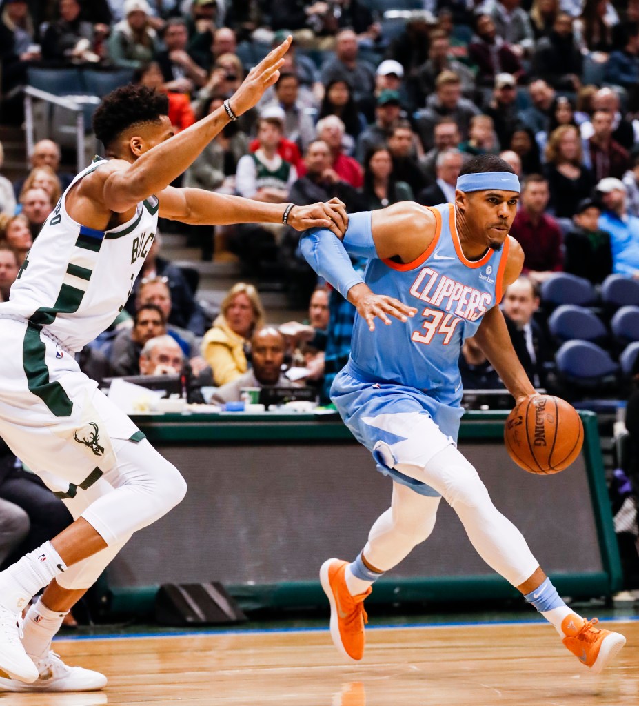 Tobias Harris drives by Giannis Antetokounmpo