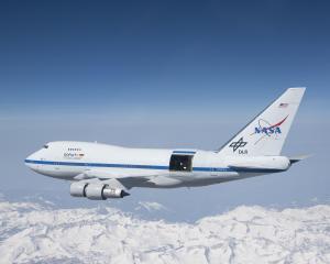 NASA's SOFIA airplane flying over mountains