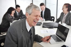 A businessman laughing, presumably at the idea of paying more taxes