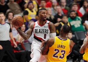 Damian Lillard drives on LeBron James.