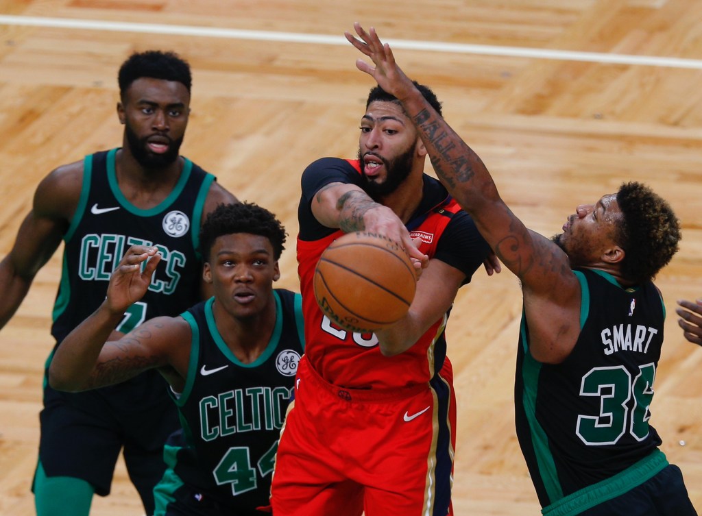 Anthony Davis gets triple-teamed by the Boston Celtics