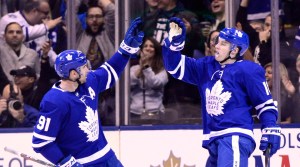 John Tavares and Mitch Marner celebrate a Toronto Maple Leafs goal.