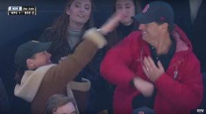 The parents of Boston Bruins Trent Frederic celebrate after their son fights in his NHL debut.