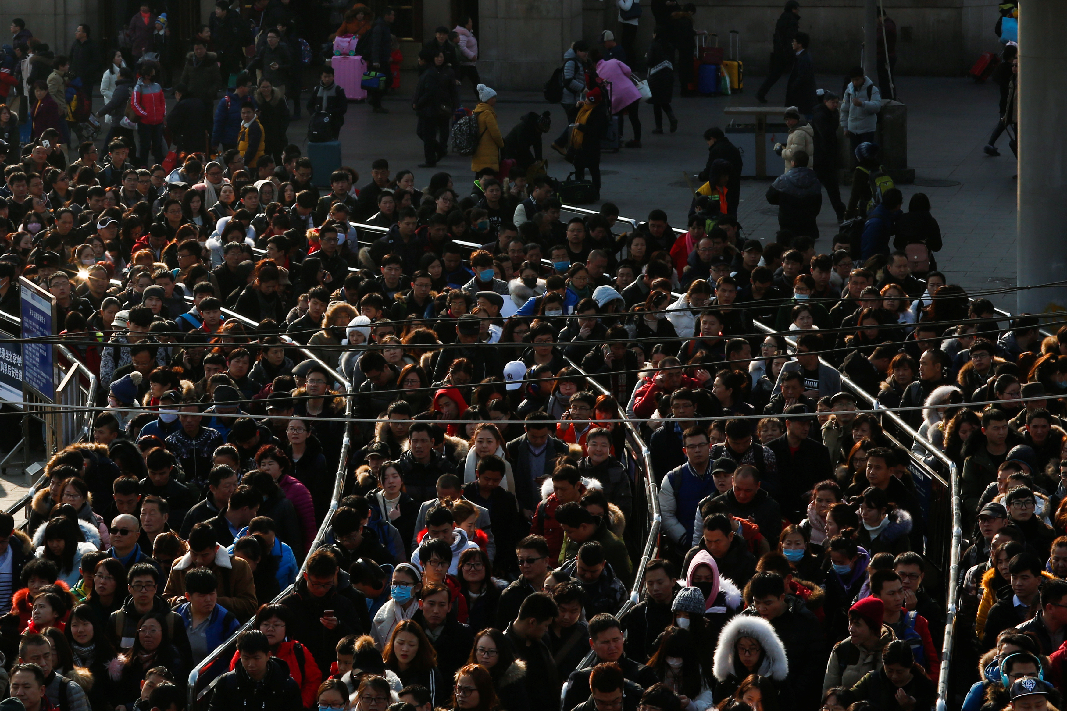 People line up at the subway station outside Beijing Railway Station on the last day of Chinese Lunar New Year holidays in Beijing.