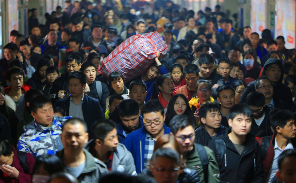 Train passengers travelling during the Spring Festival travel rush ahead of Chinese Lunar New Year arrive at Hengyang Railway Station in Hunan