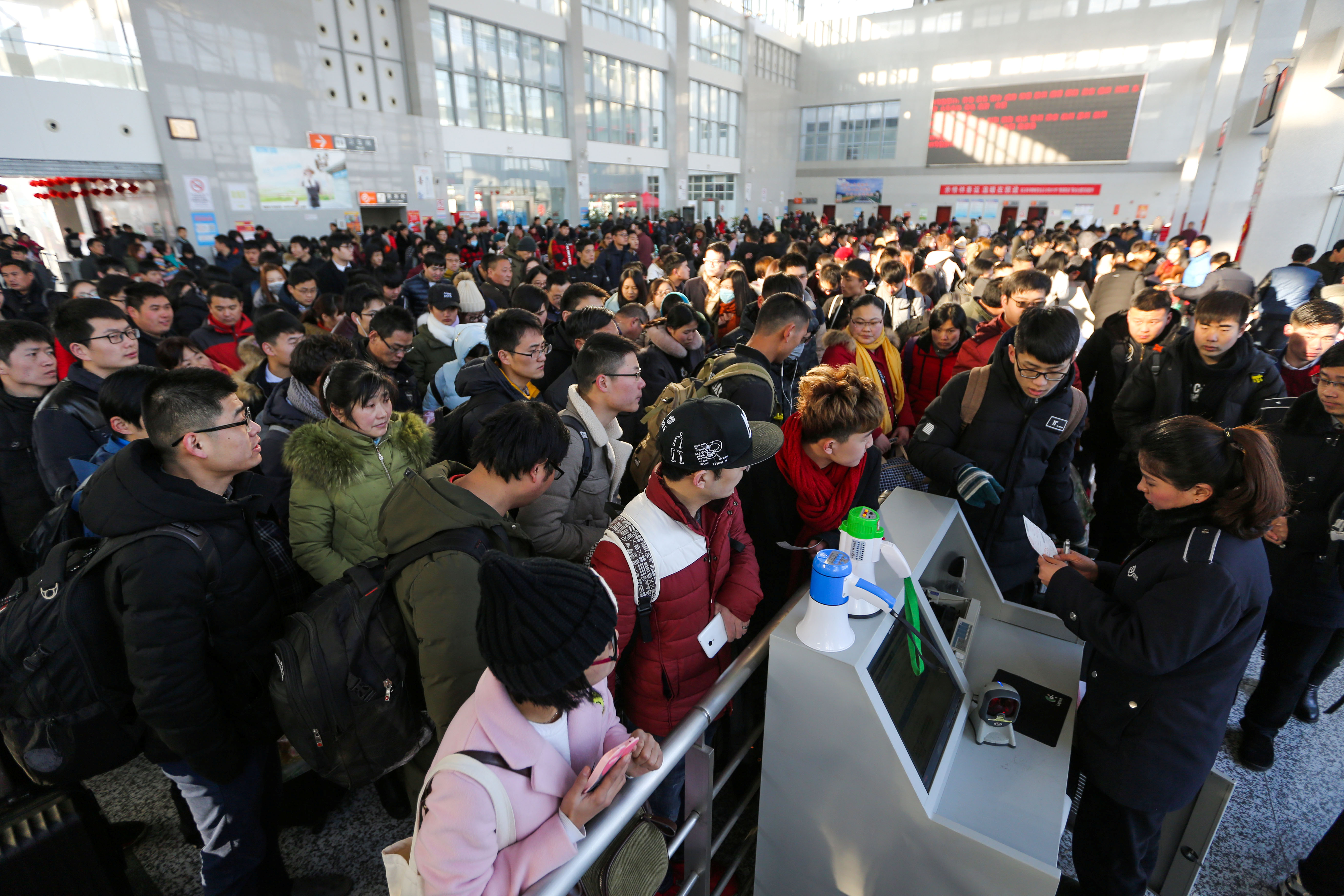 People wait to board trains on the last day of Chinese Lunar New Year holidays at a railway station in Lianyungang.