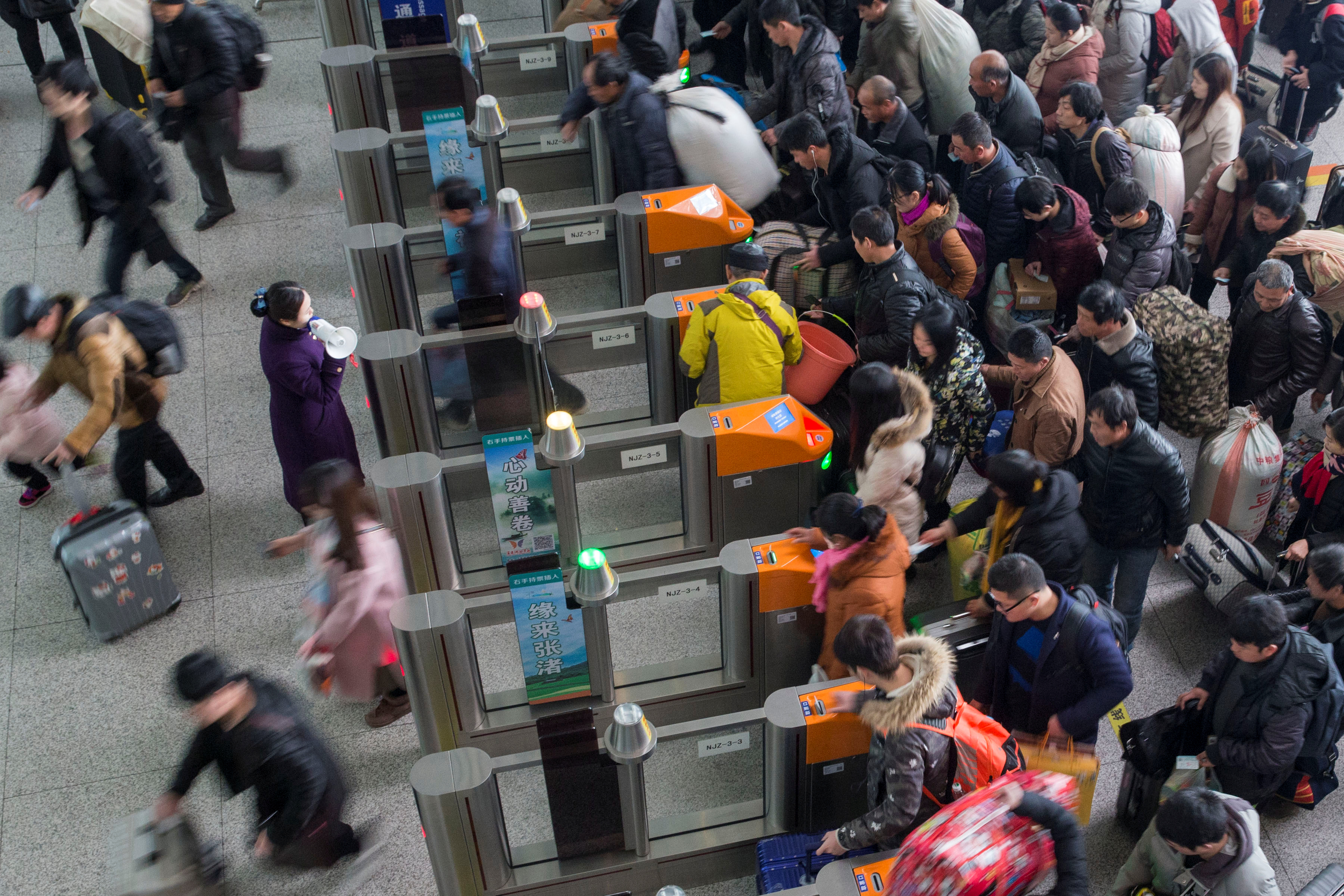 Passengers wait to board trains ahead of the Chinese Lunar New Year, at Nanjing Railway Station