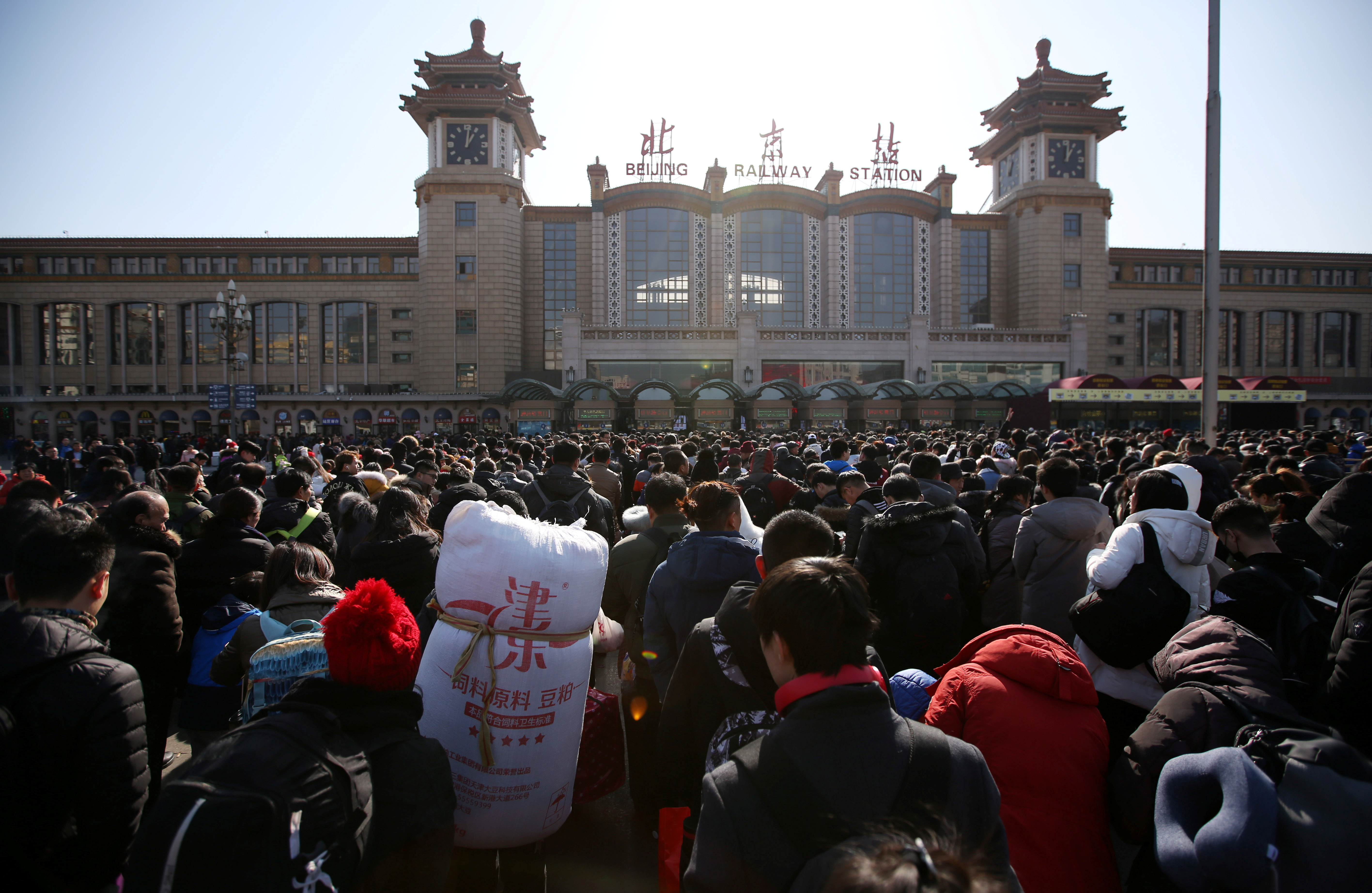 Passengers wait to board trains at Beijing Railway Station as they travel ahead of the Chinese Lunar New Year in Beijing