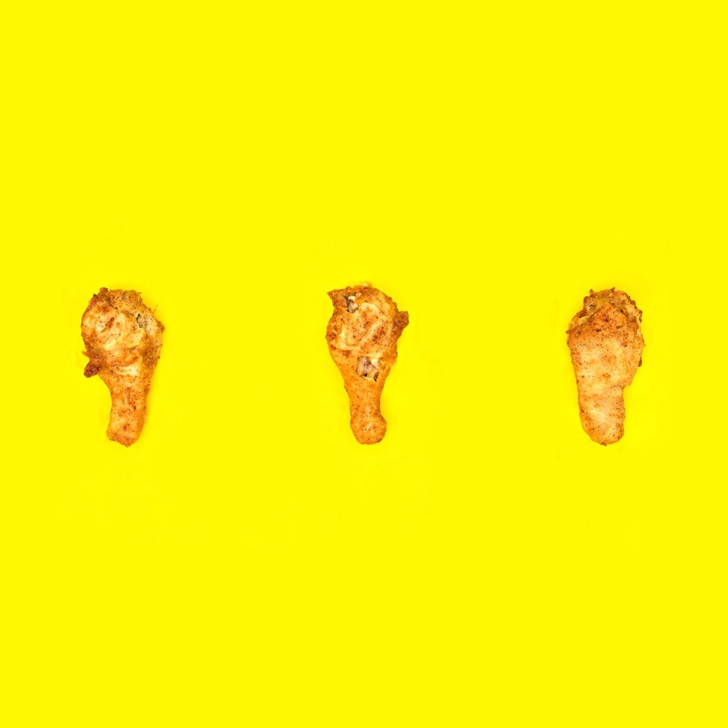 pieces of fried chicken in front of a bright yellow background