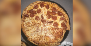 screenshot of a shane dawson video showing half cheese, half pepperoni pizza from chuck e. cheese's