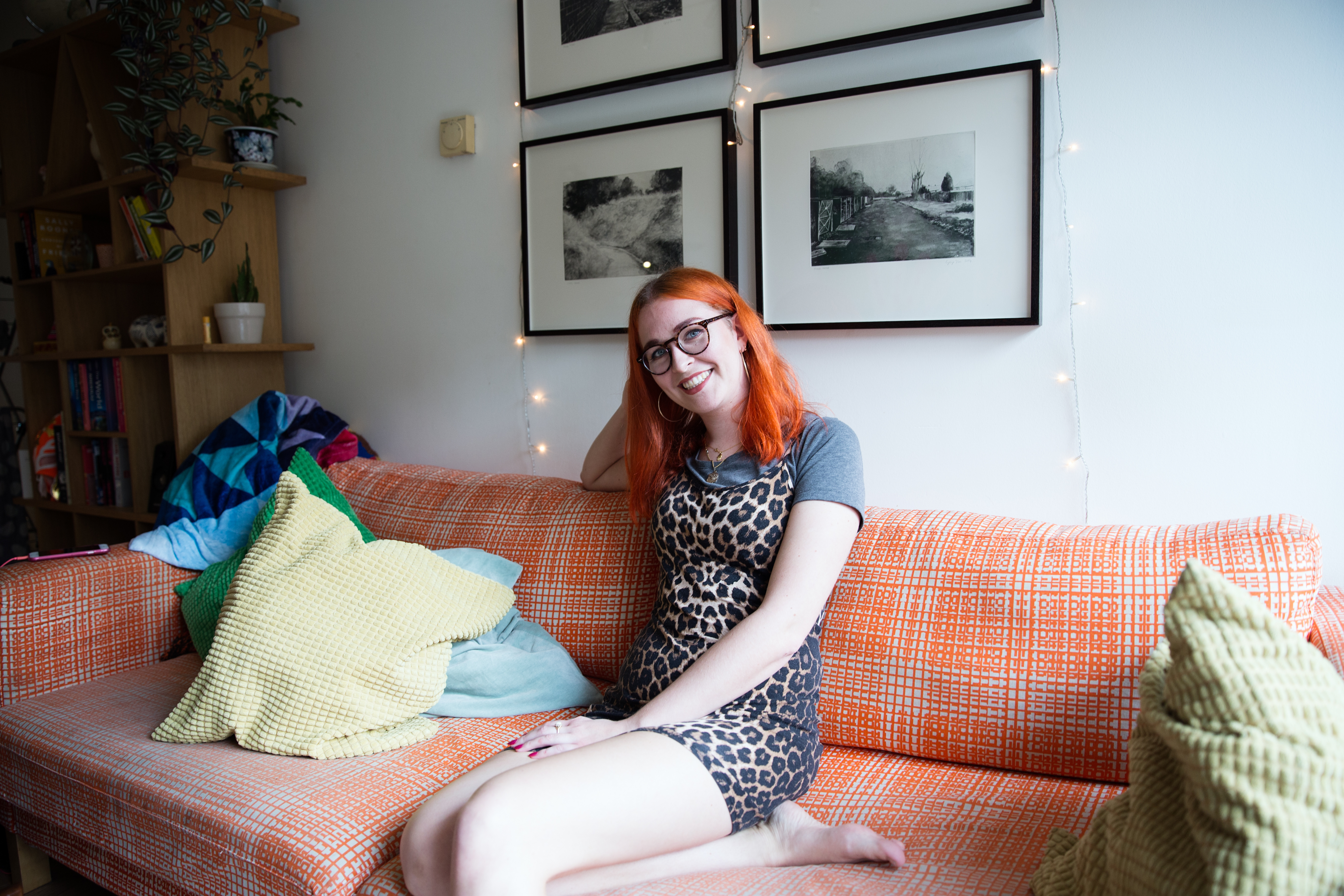 Smiling girl sitting on sofa