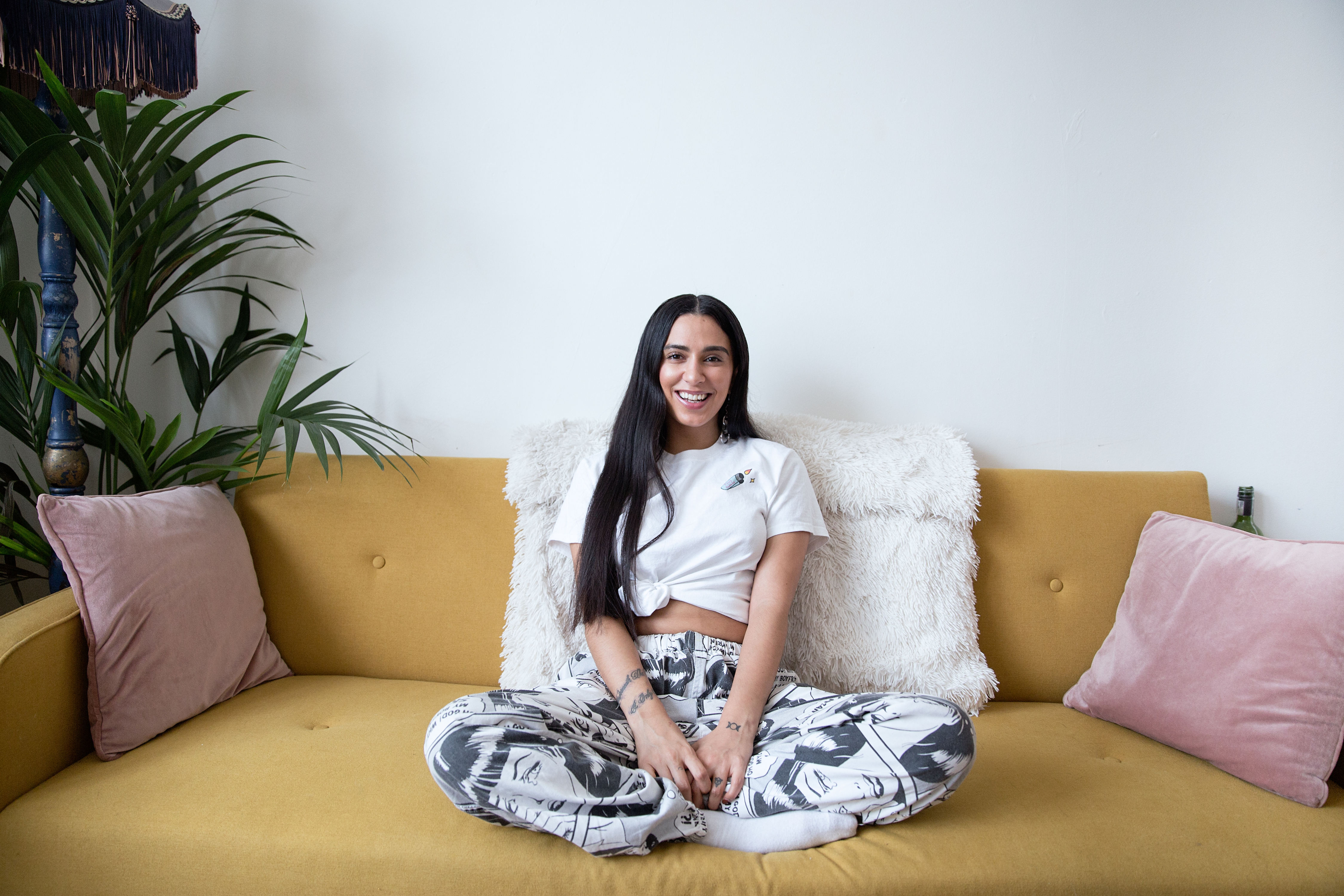 Smiling womxn sitting on sofa