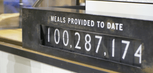 a black and white ticker that says "100,287,174 meals provided to date"