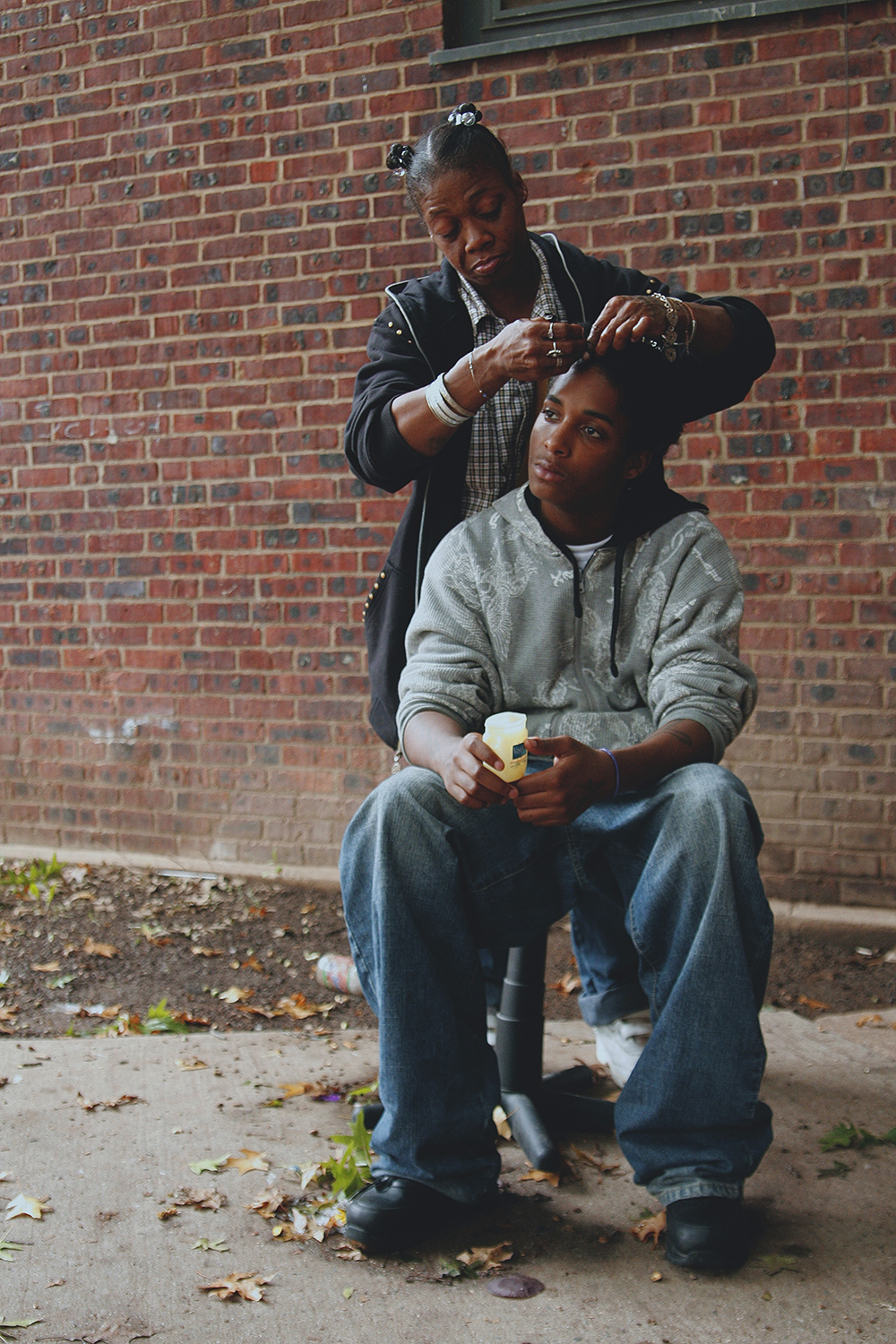 Auntie braiding at the Baxter Terrace Projects