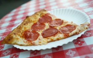 slice of pepperoni pizza on a paper plate