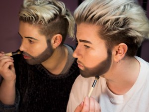 Two drag kings putting on makeup